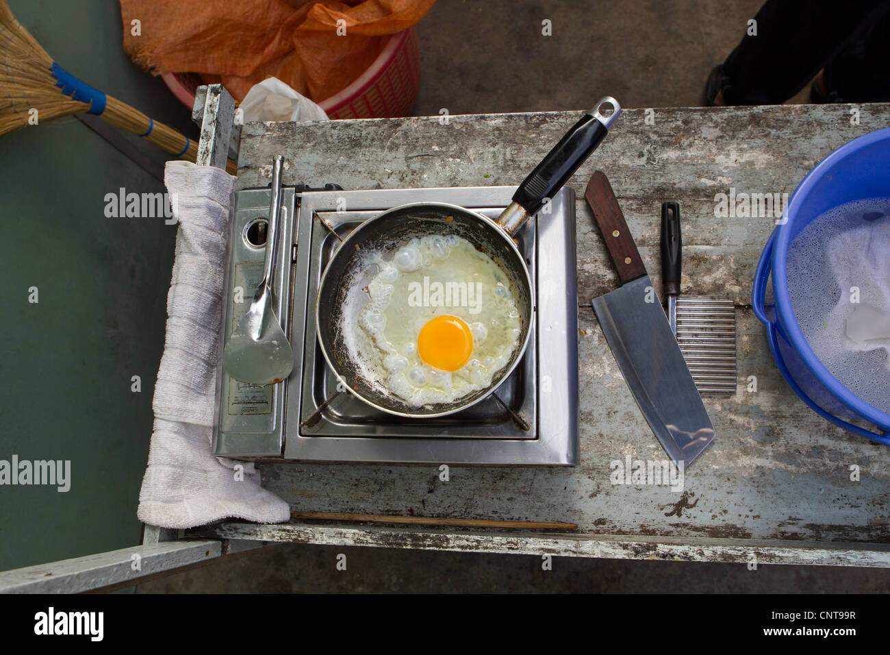 Egg frying in pan on hot plate, overhead view Stock Photo Alamy