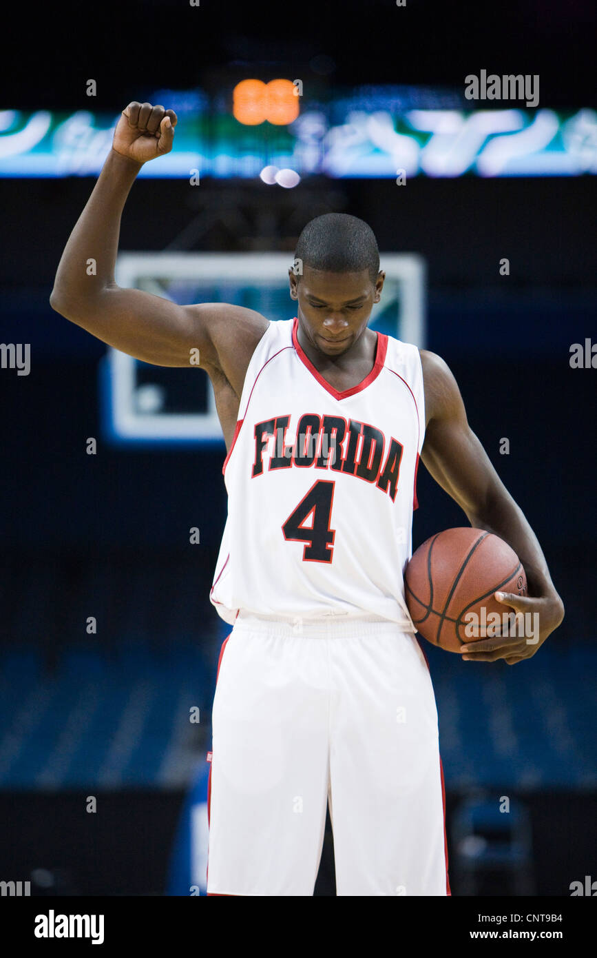 Basketball player cheering with arm raised, portrait Stock Photo Alamy