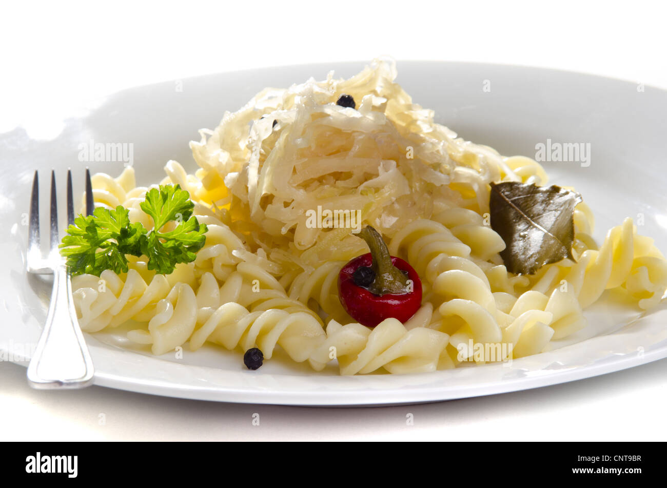 Sauerkraut with noodle and bay leaf on a white plate Stock Photo