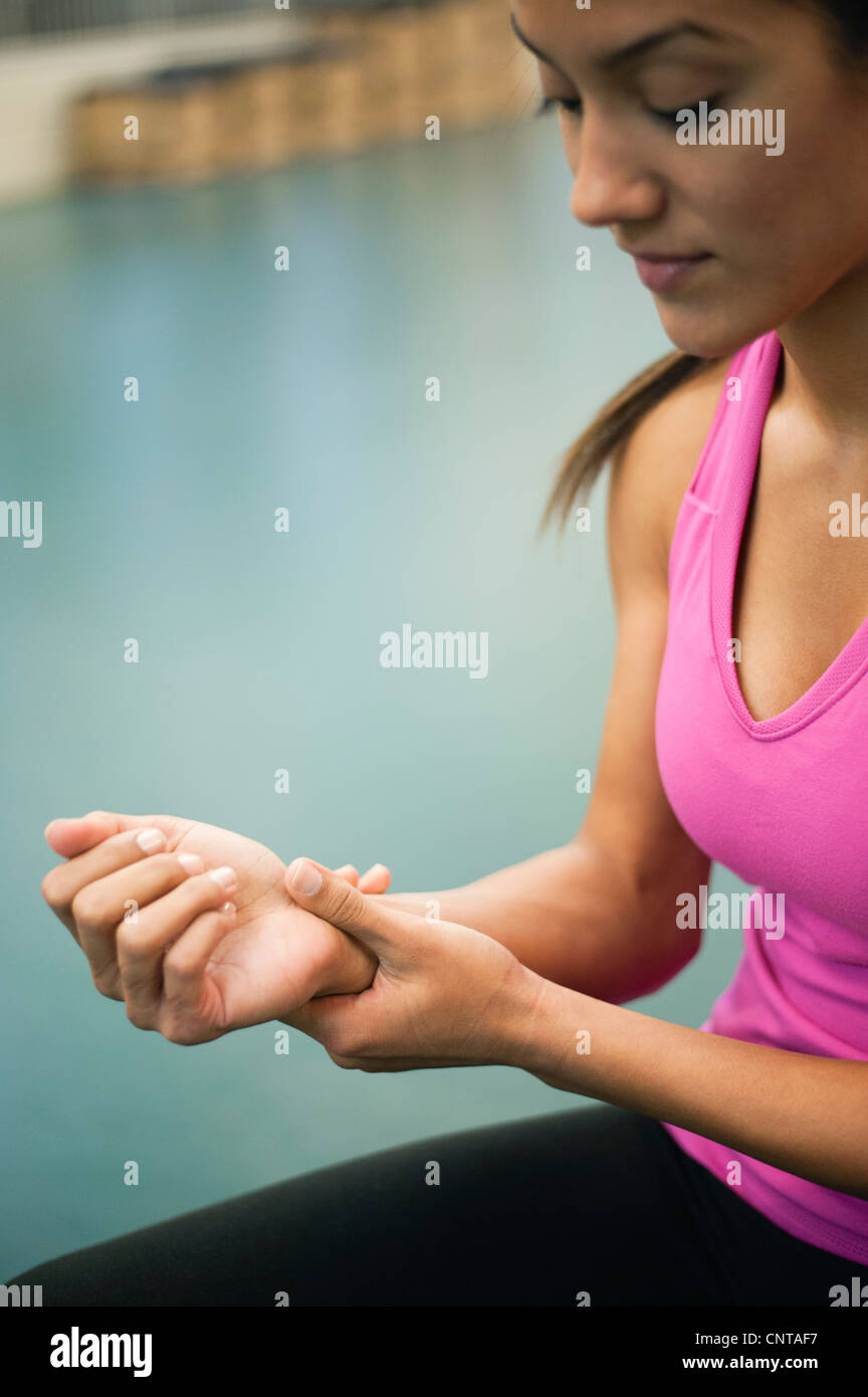 Young woman rubbing wrist Stock Photo Alamy