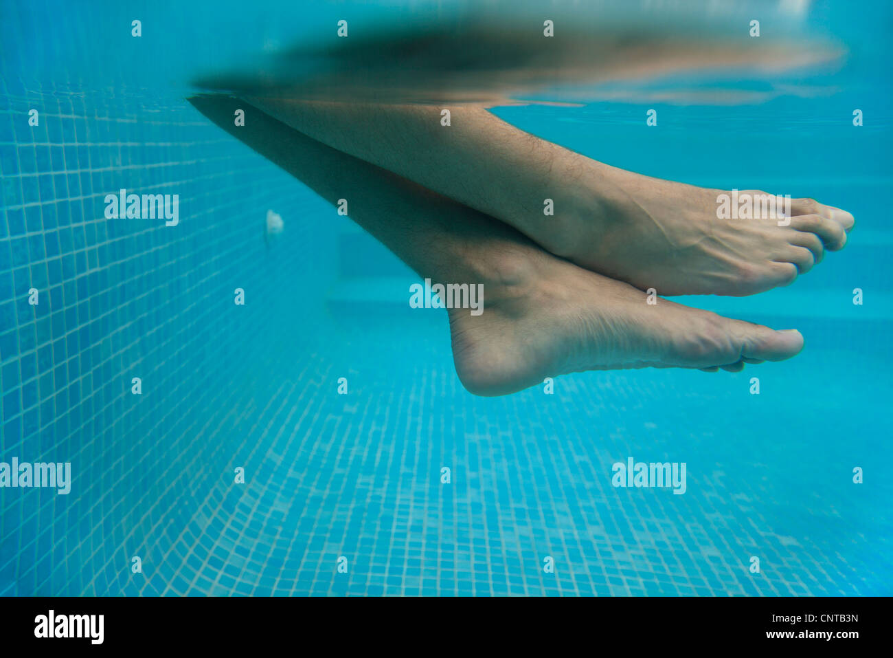 Man's legs in water, underwater view Stock Photo