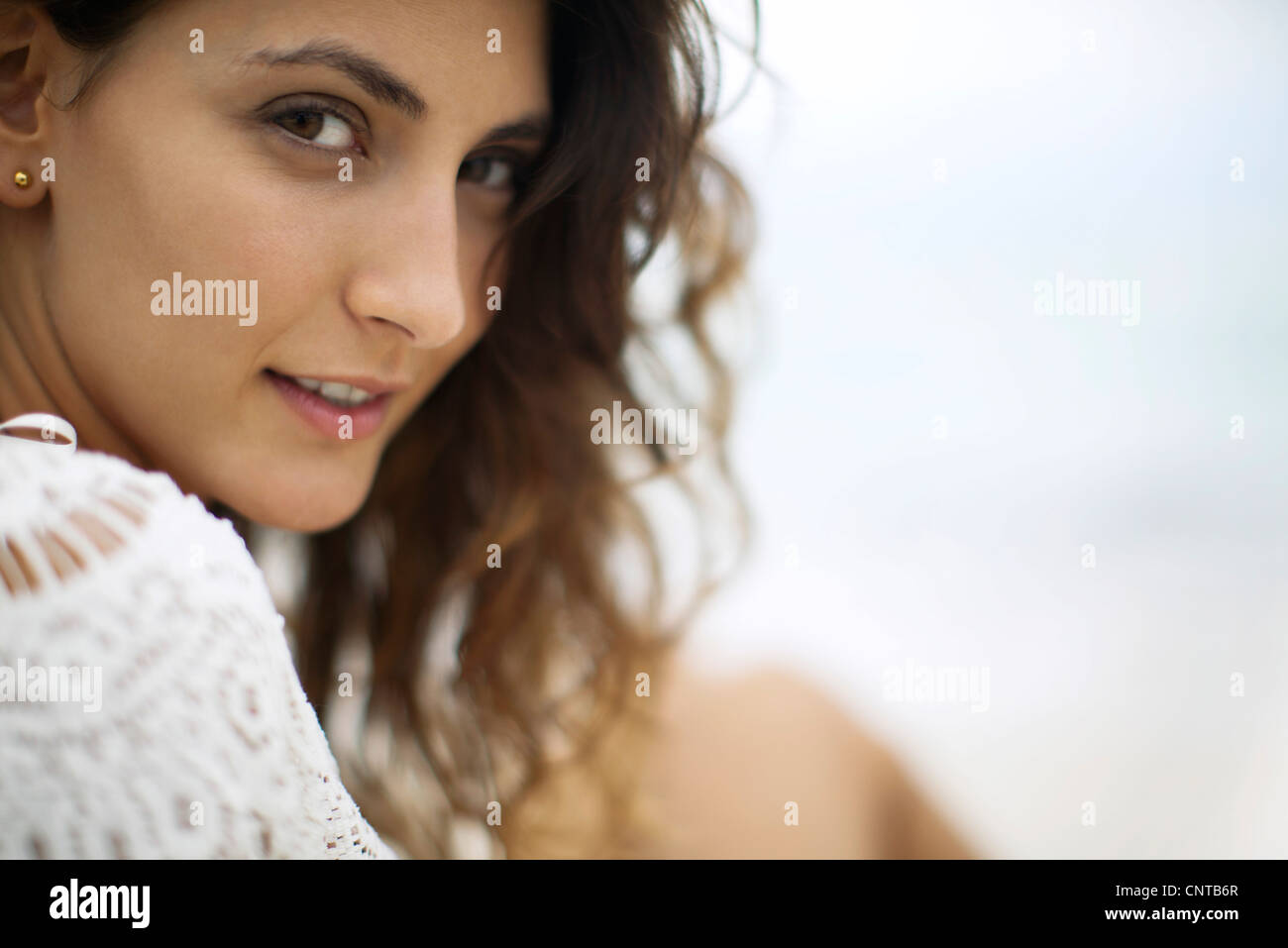 Young woman looking over shoulder, cropped Stock Photo