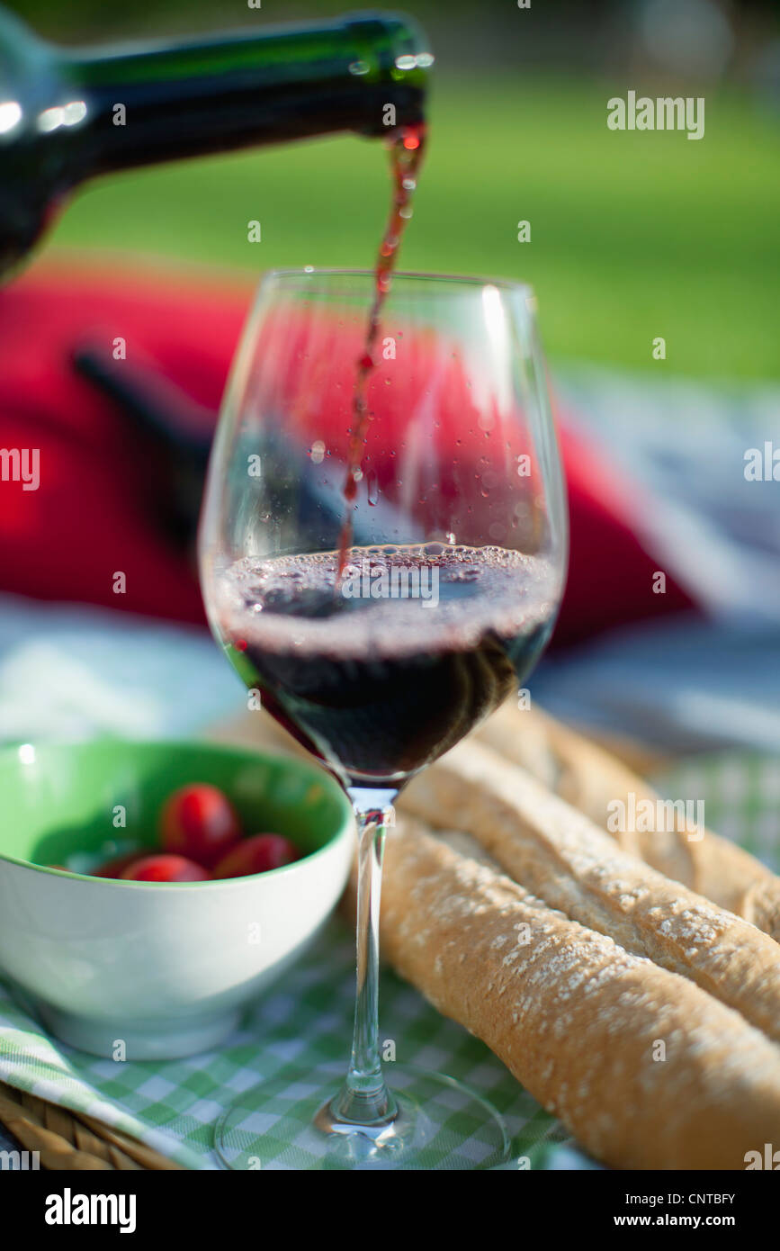 Pouring red wine at picnic Stock Photo Alamy