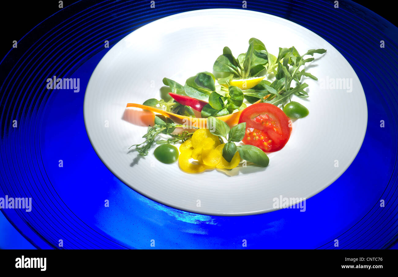 plate with portion of fresh mixed salad salat mix mixture fitness fit FOOD lamb's lettuce salad mache vegetables tomato Stock Photo