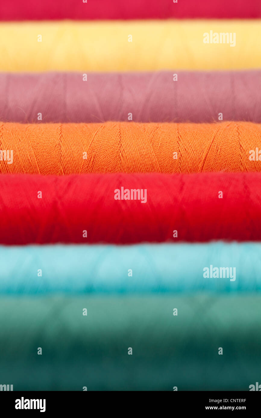 colourful cotton thread on spool as background Stock Photo