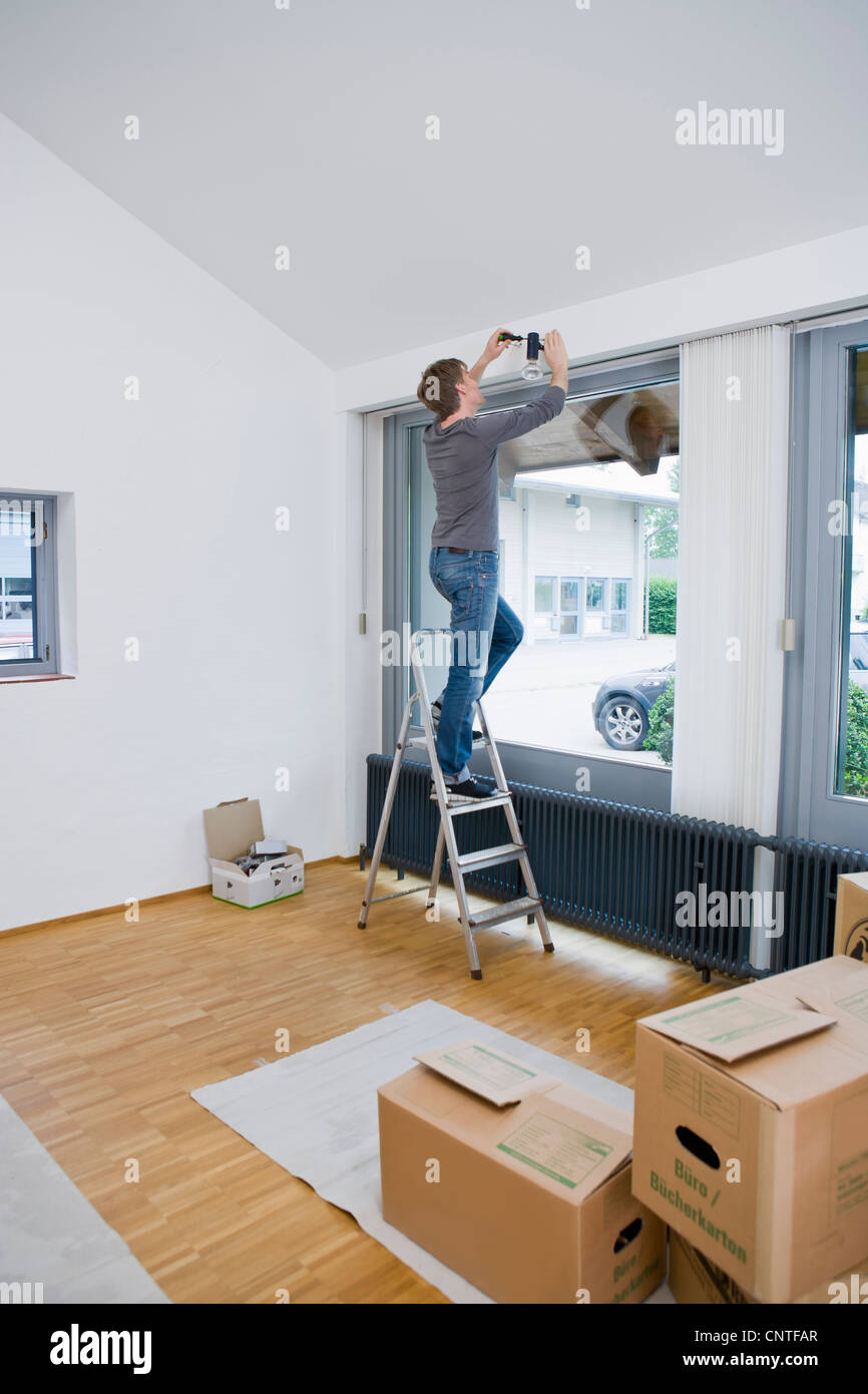 Man painting room in new house Stock Photo