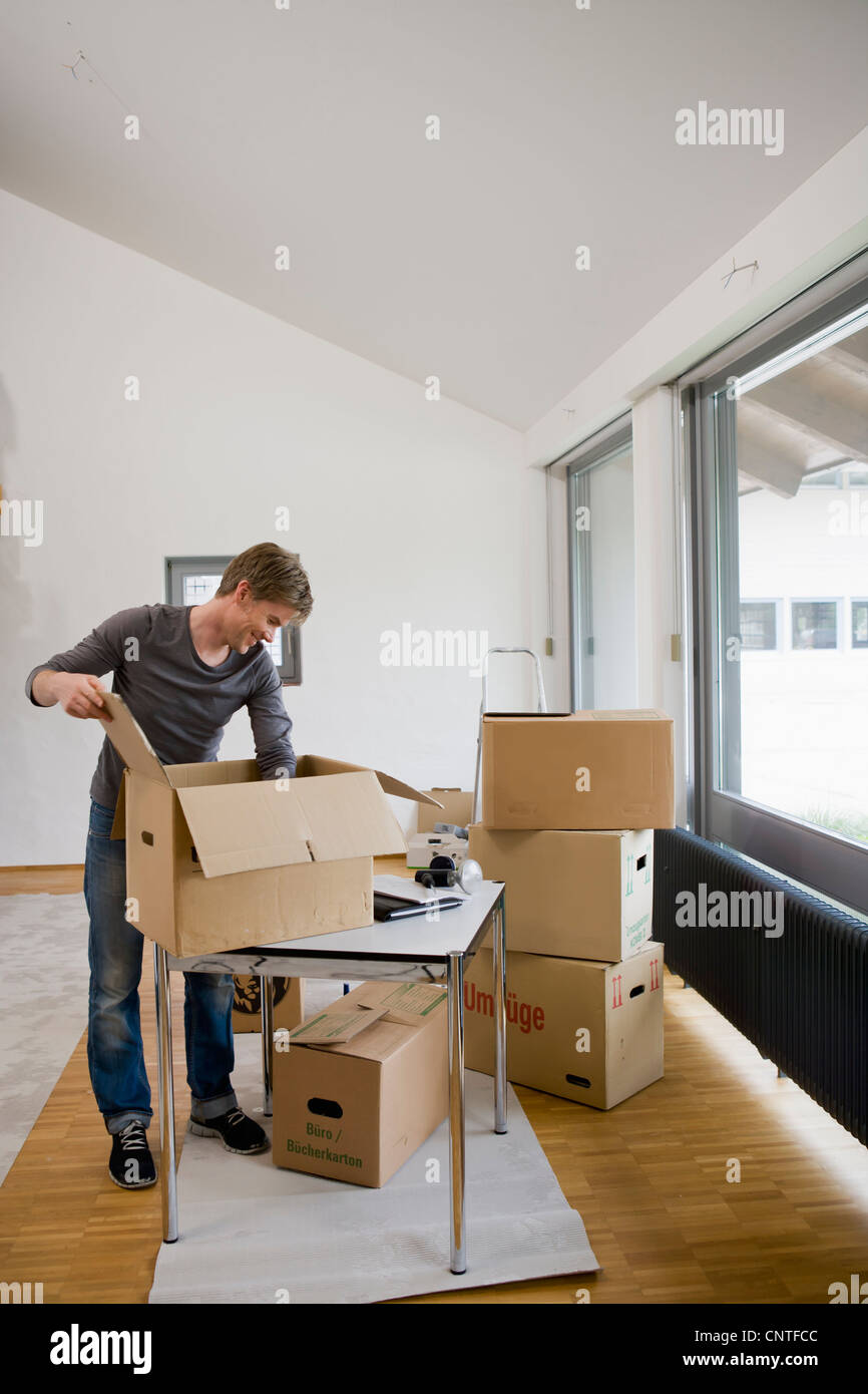 Man unpacking cardboard boxes Stock Photo Alamy