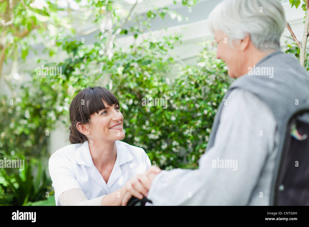Nurse talking to older patient outdoors Stock Photo