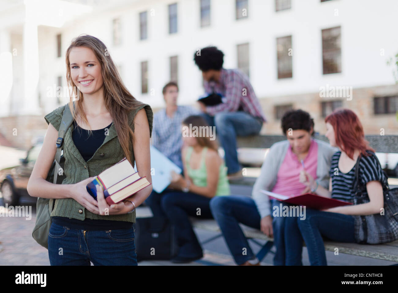 Student carrying books on campus Stock Photo Alamy