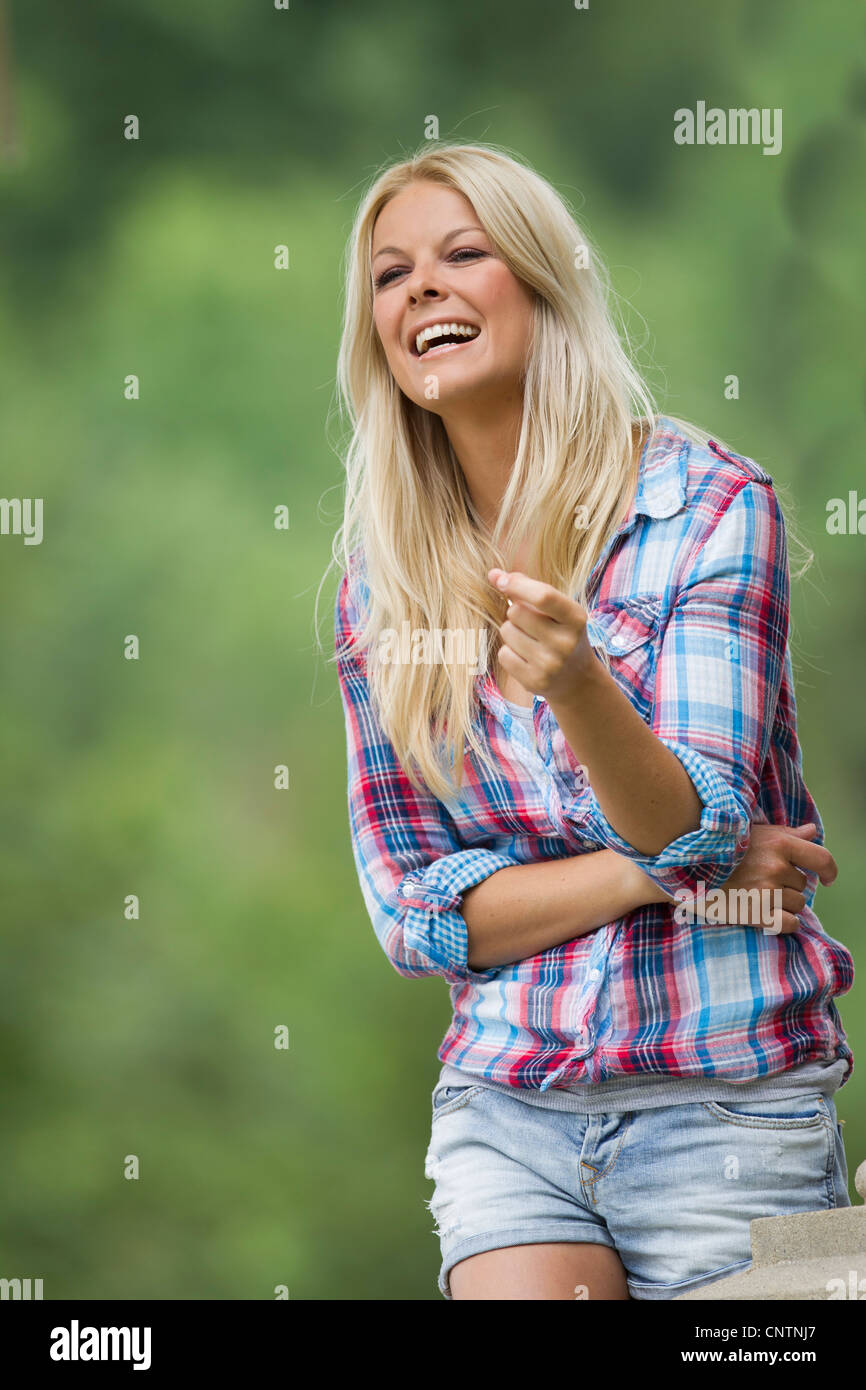 Woman standing in park crossed hi-res stock photography and images - Alamy