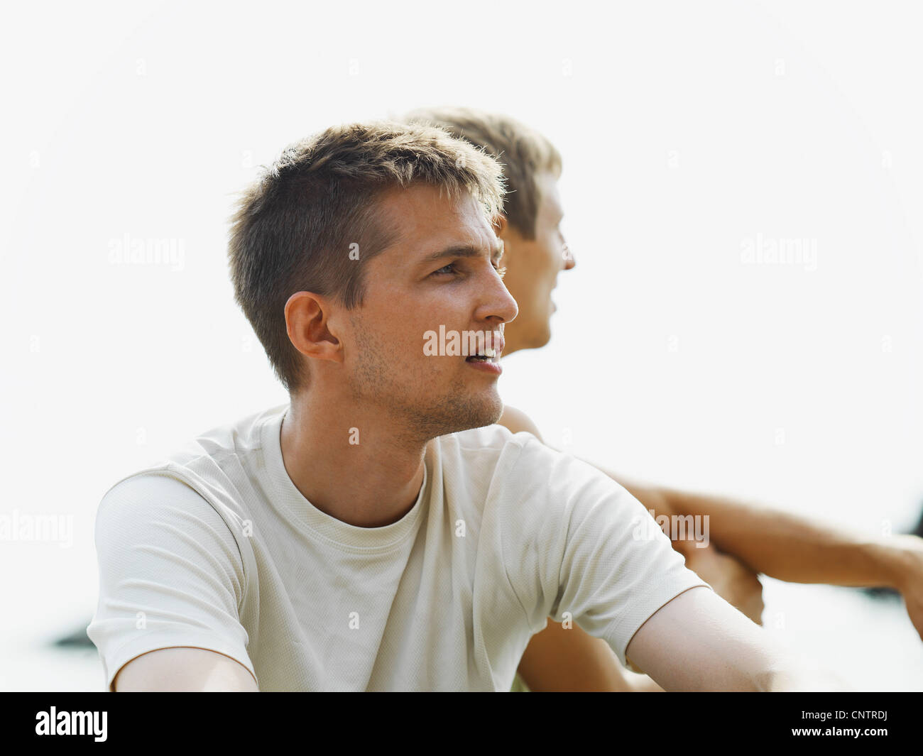 Men sitting together outdoors Stock Photo