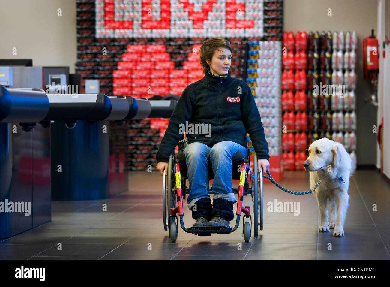 Invalid and physically disabled person in wheelchair shopping with