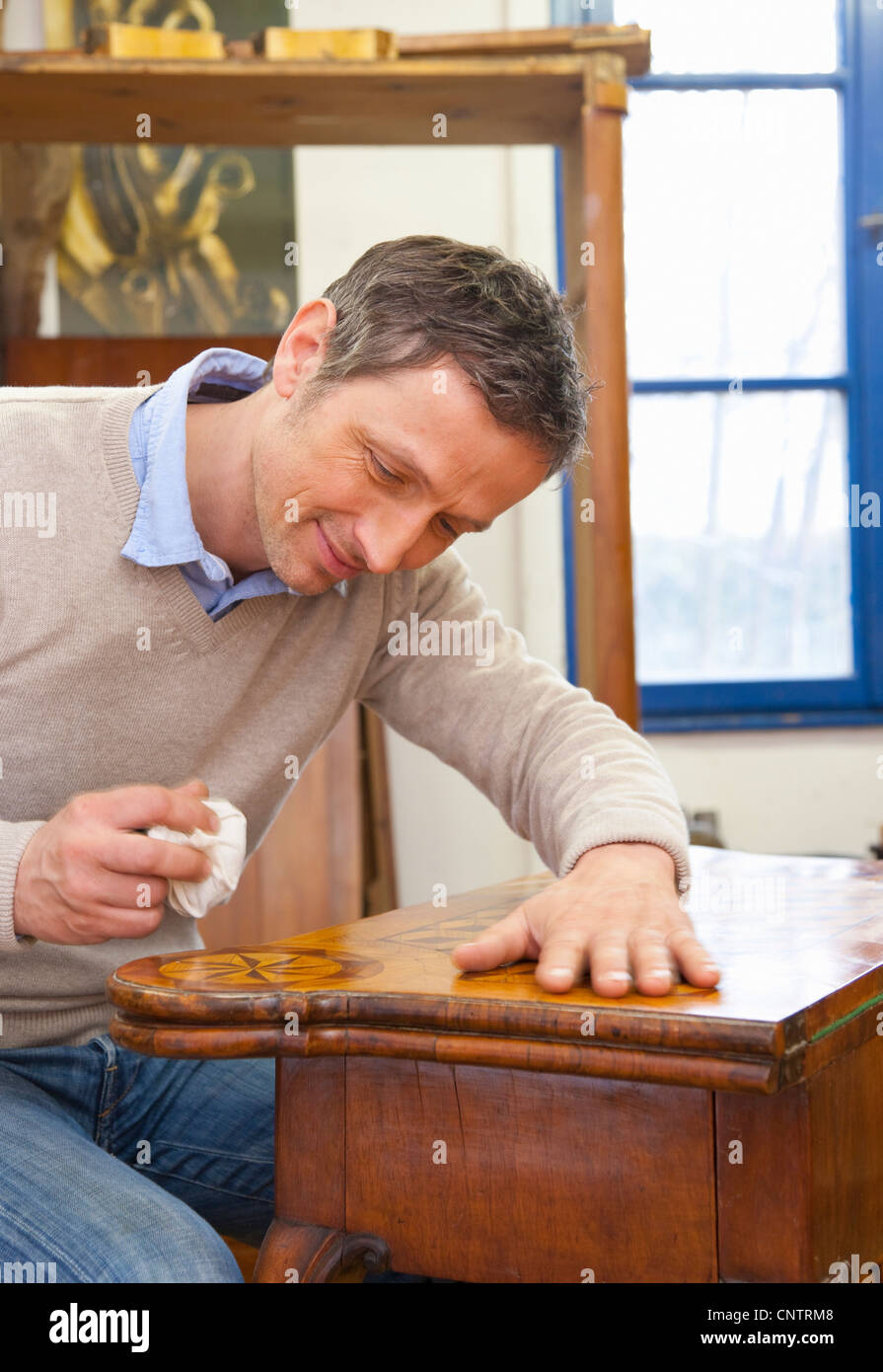 Carpenter buffing wooden table Stock Photo Alamy