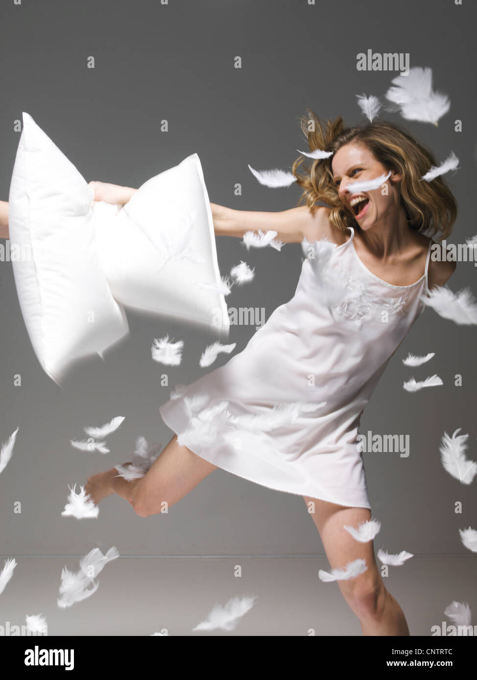 Woman hitting man with pillow hires stock photography and images Alamy