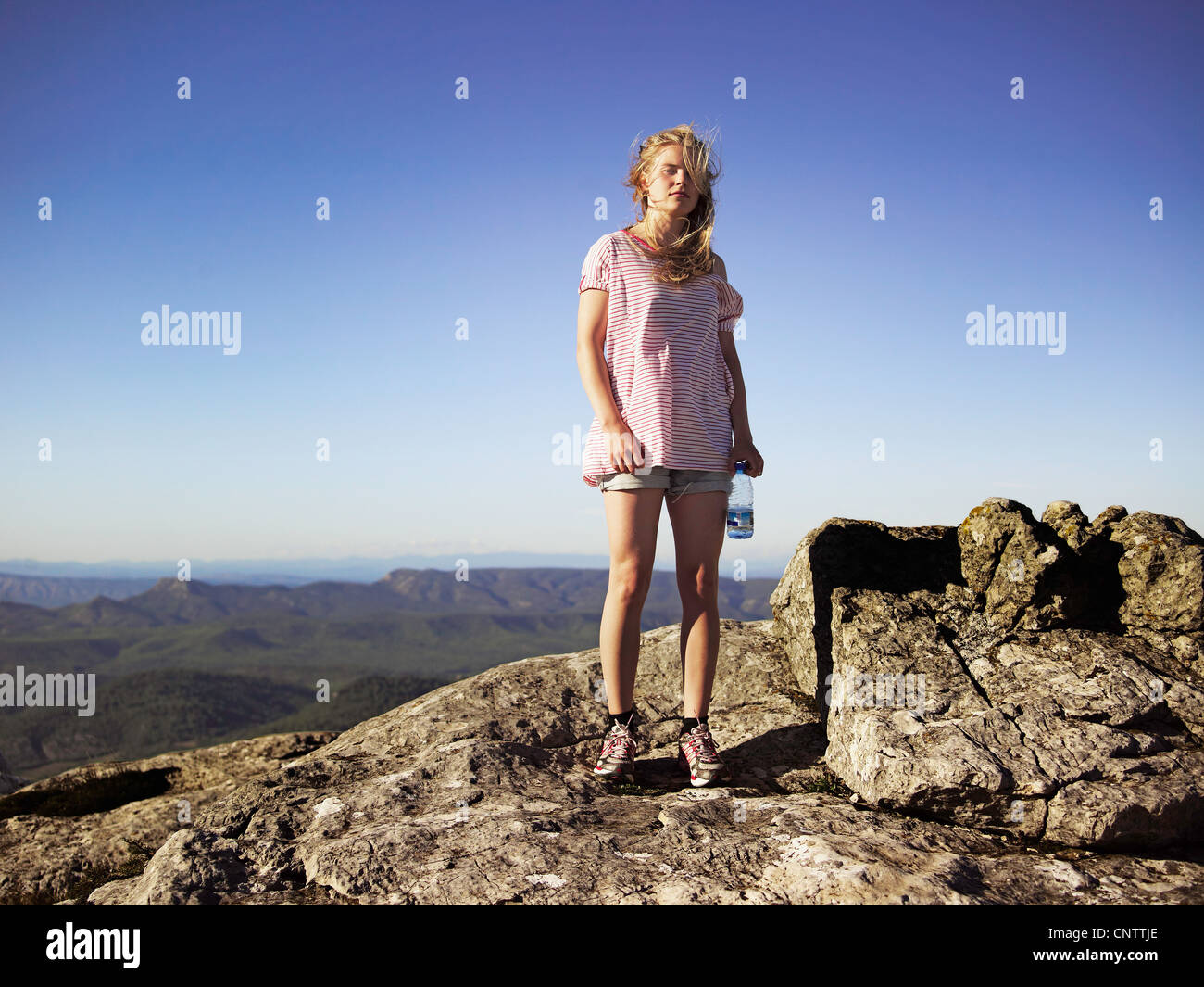 Hiker standing on top of rocky mountain Stock Photo - Alamy