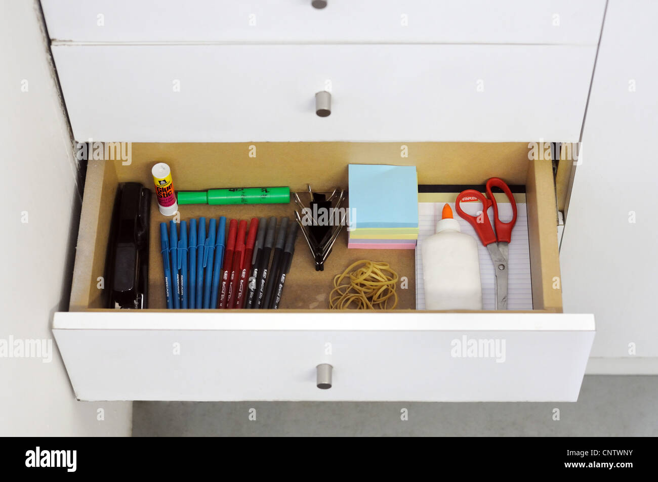 A before and after view of a clean and messy drawer. Stock Photo