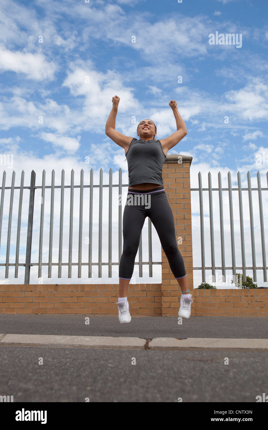 Runner jumping for joy outdoors Stock Photo - Alamy