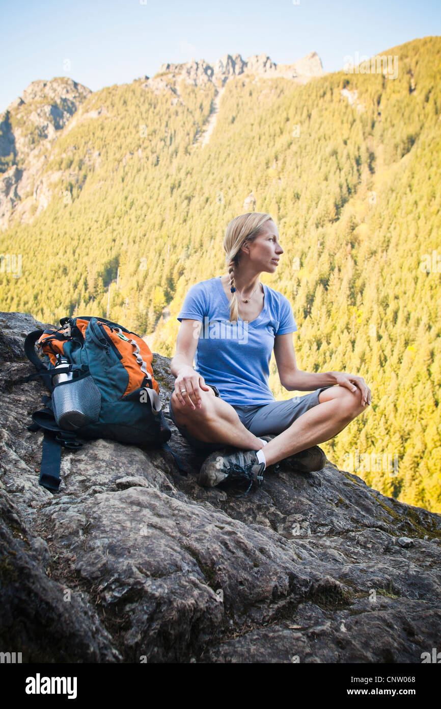 A woman hiker sitting on the edge of a rocky cliff, Little Si Trail ...