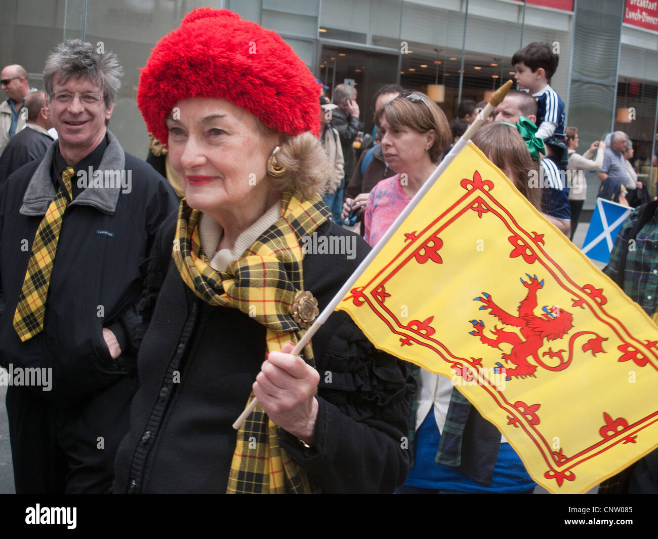 Scottish bagpipers, dancers, and onlookers enjoy the annual Tartan Day Parade on 6th Ave. in New York City Stock Photo