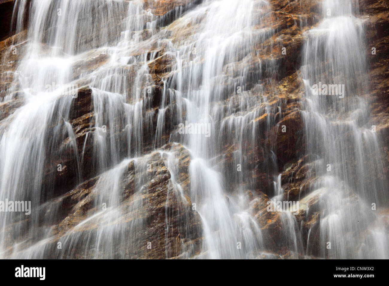 waterfall avalanching down a steep rock wall, Austria, Hohe Tauern National Park Stock Photo
