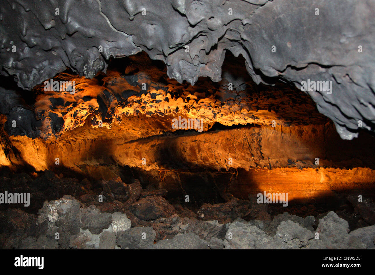 tunnel in volcanic rock illuminated by glowing lava, Canary Islands, Lanzarote Stock Photo