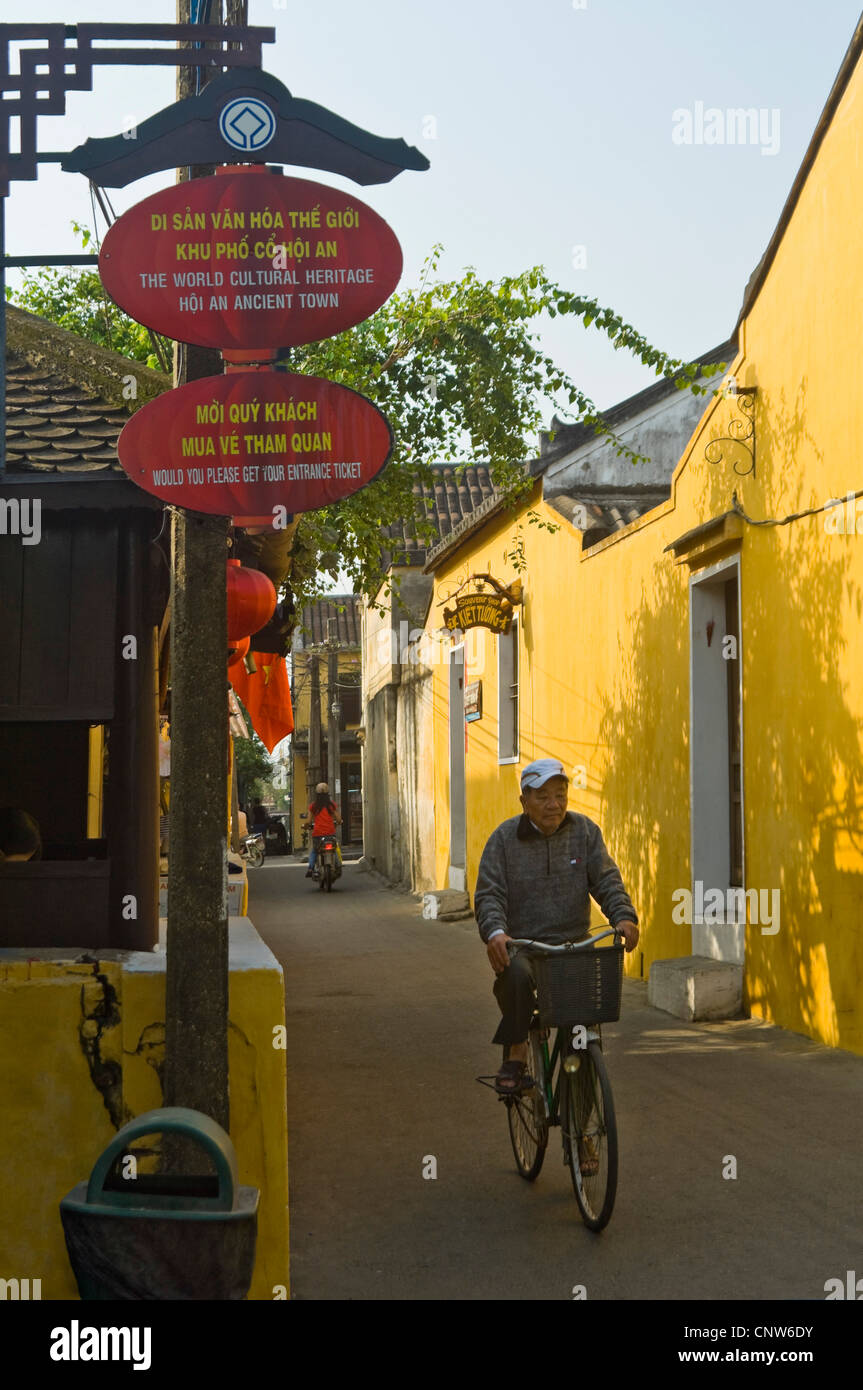 Vertical close up of sign written in english and Vietnamese at one of the entrances to the ancient town of Hoi An on a sunny day Stock Photo