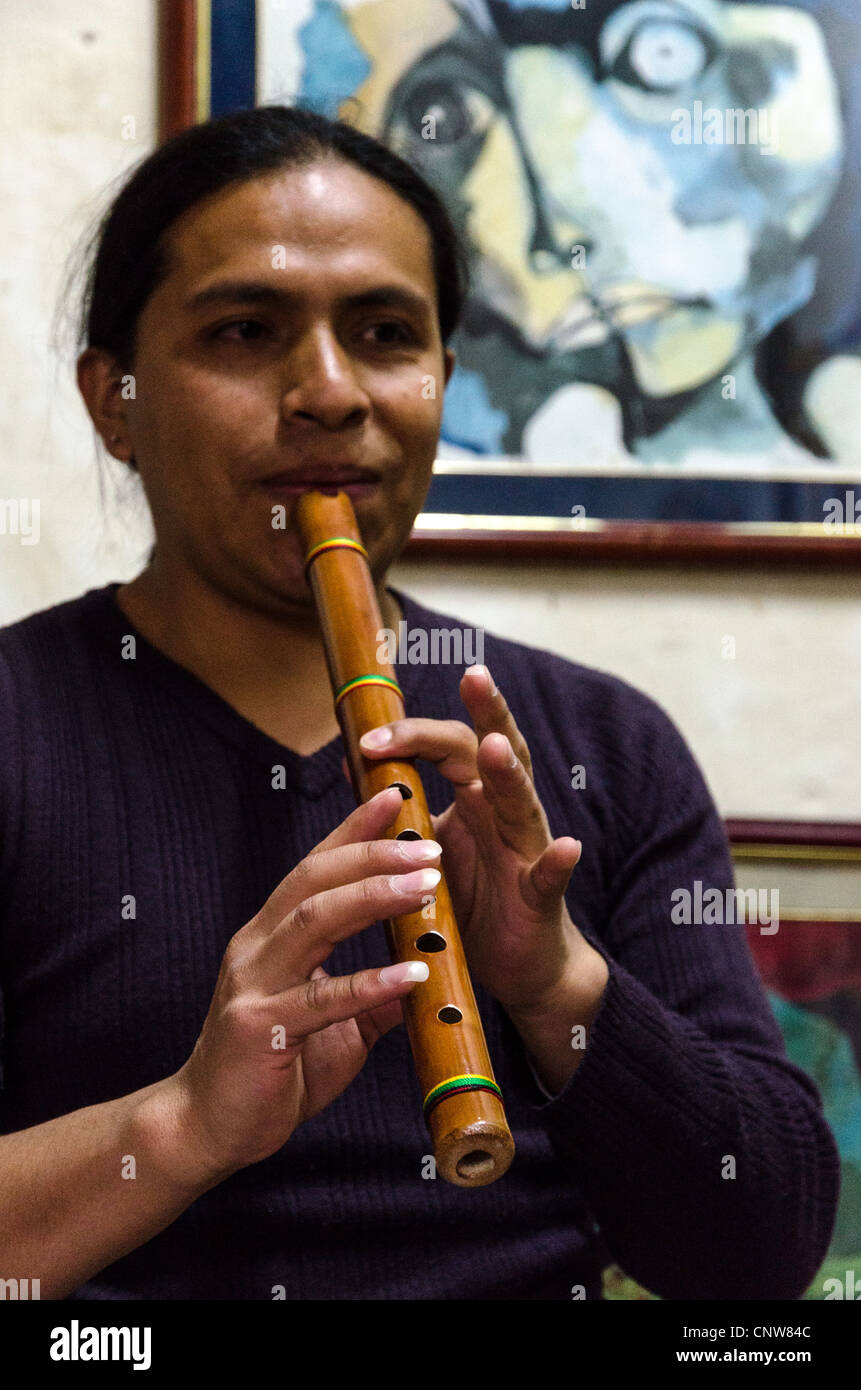 Man playing traditional music instrument at Otavalo market Ecuador Stock Photo
