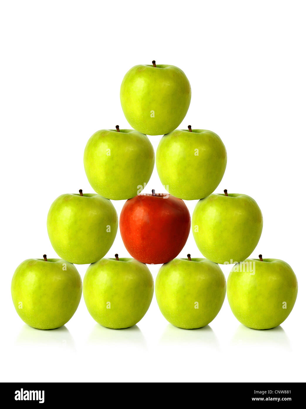 green apples on a pyramid shape with one red apple in the middle, be different Stock Photo