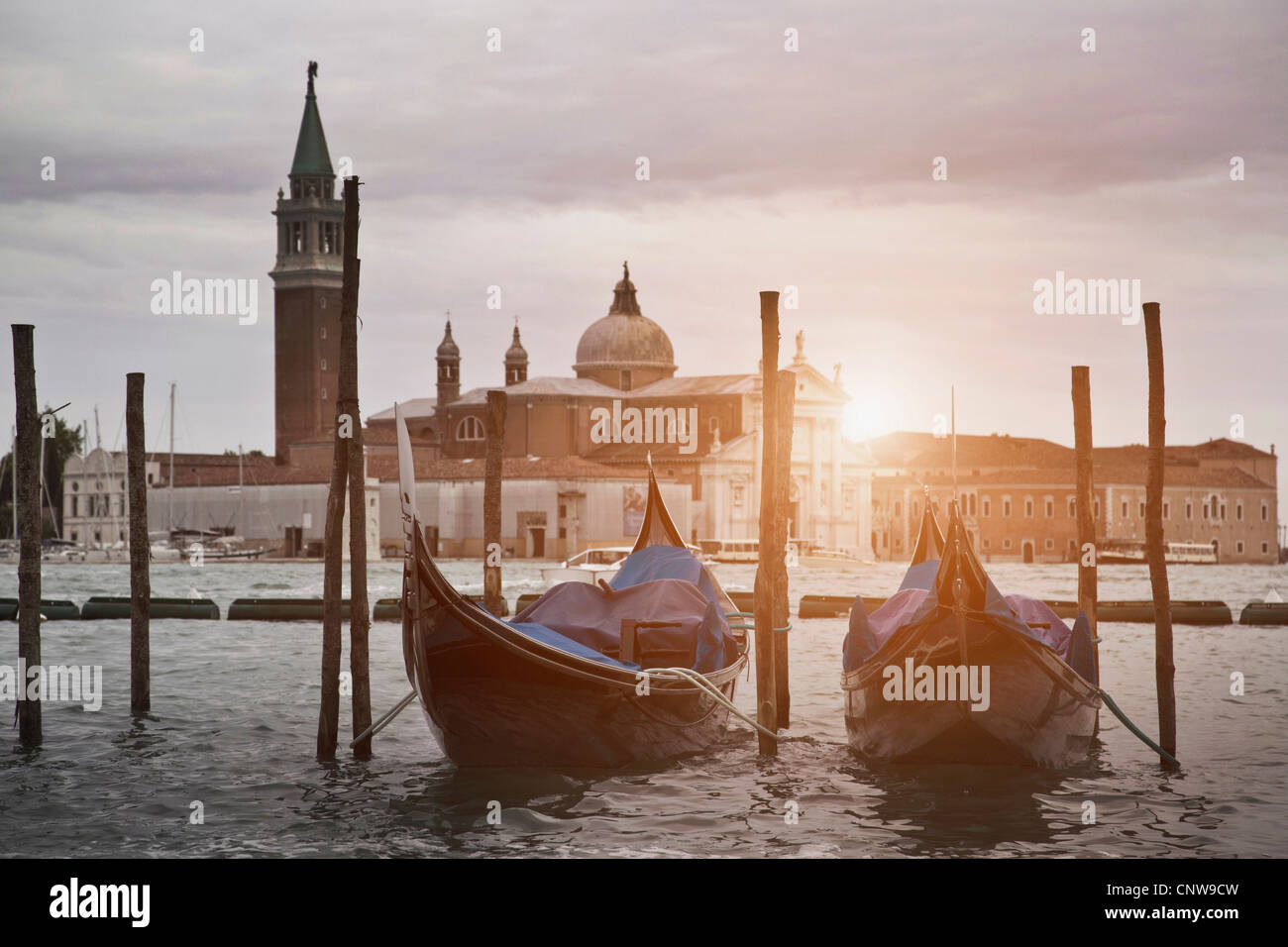 Gondolas docked on urban canal Stock Photo