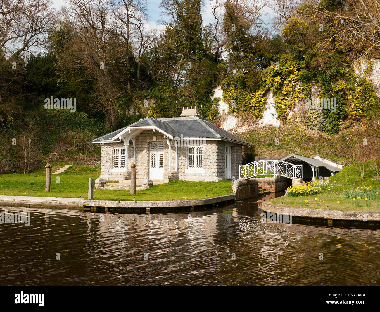 Picturesque stone riverside house and boat house,on the River Thames, Oxfordshire, UK Stock Photo