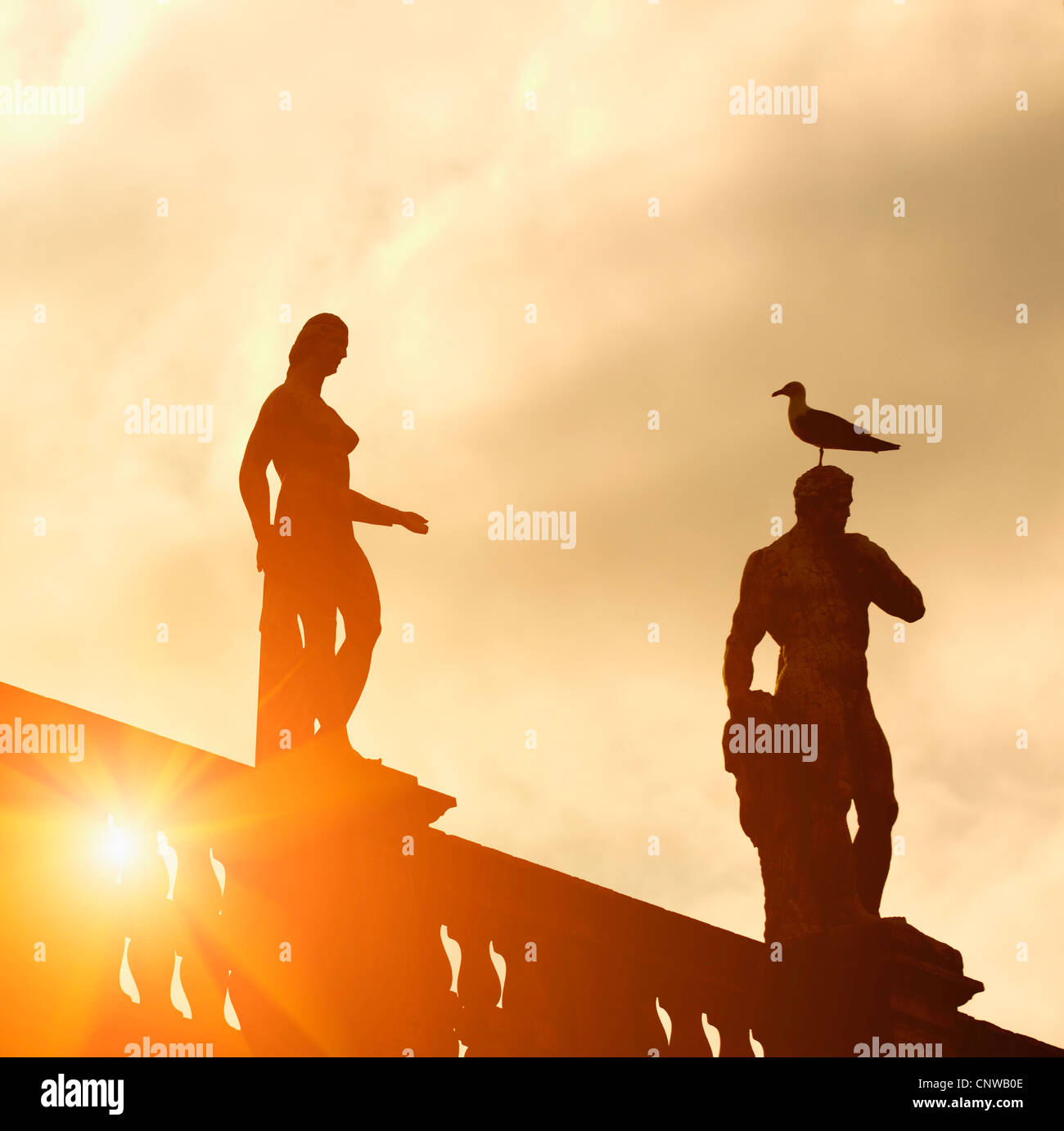 Dawn sky with silhouette of statues hi-res stock photography and images ...