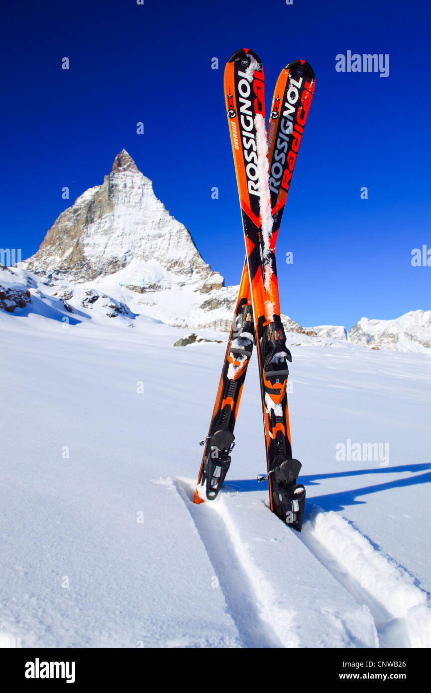 skis sticking in the snow in front of the Matterhorn, Switzerland
