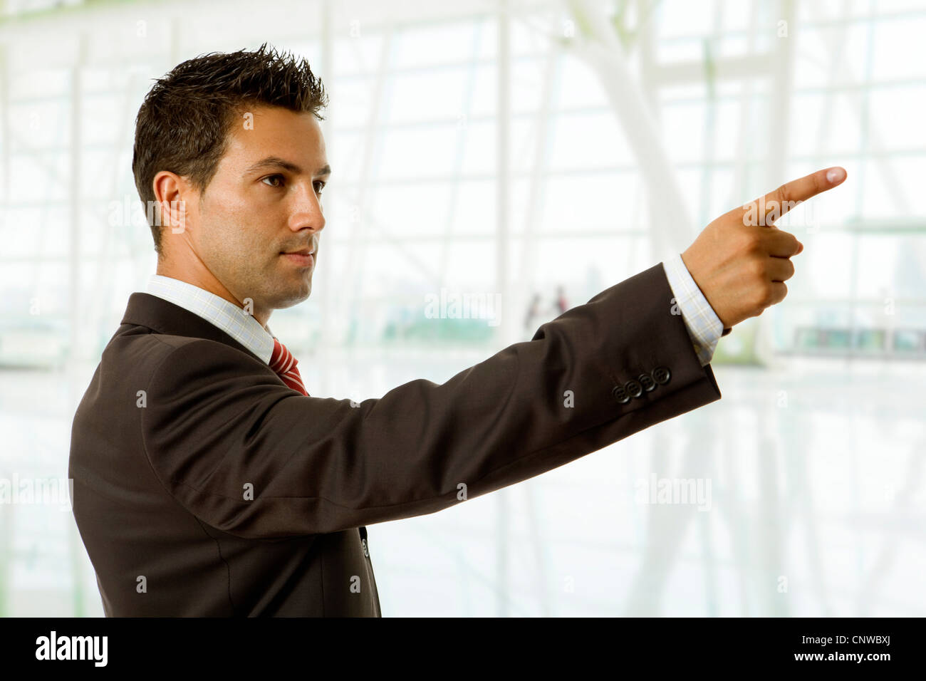 young business man in a suit pointing with his finger Stock Photo - Alamy