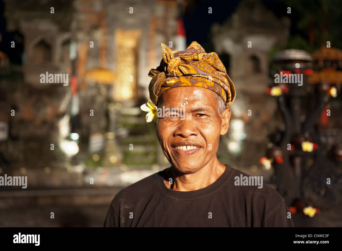 Helper getting ready for the Balinese dancing show, Ubud, Bali, Indonesia Stock Photo