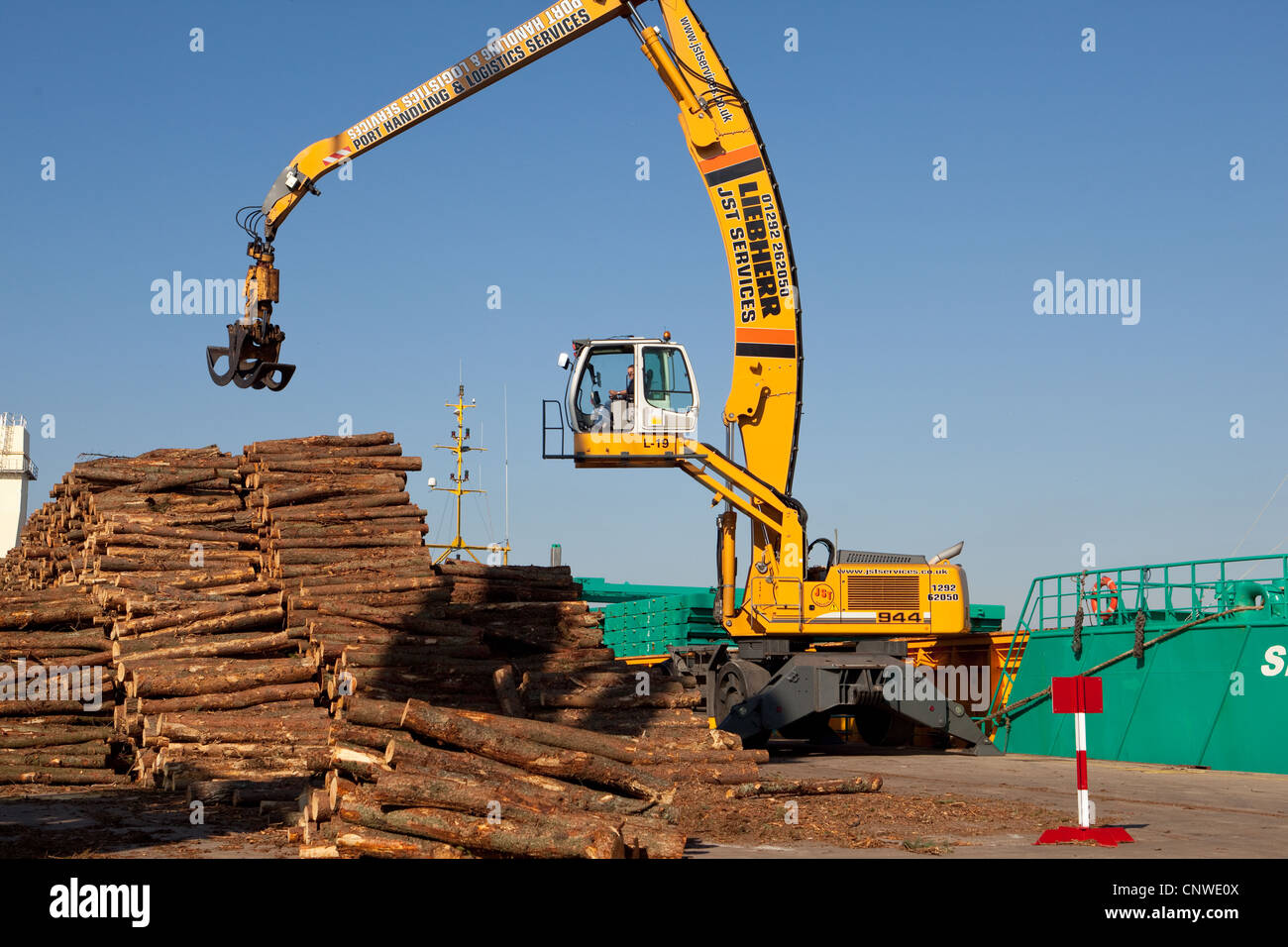 Logging Industry  Loading fresh timber onto cargo Vessel Montrose Port UK Stock Photo