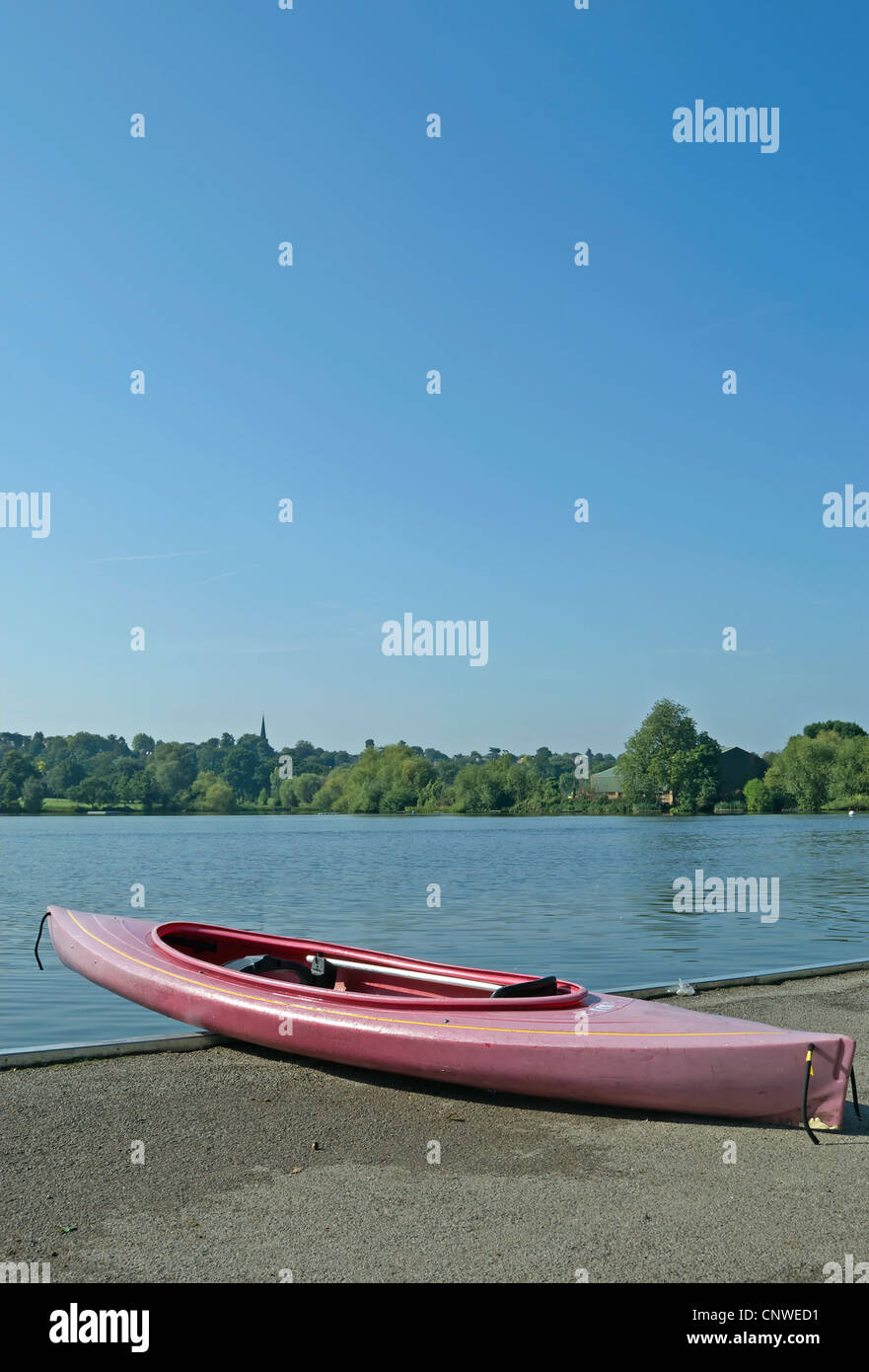 pink canoe on ground beside the lake at wimbledon park, southwest