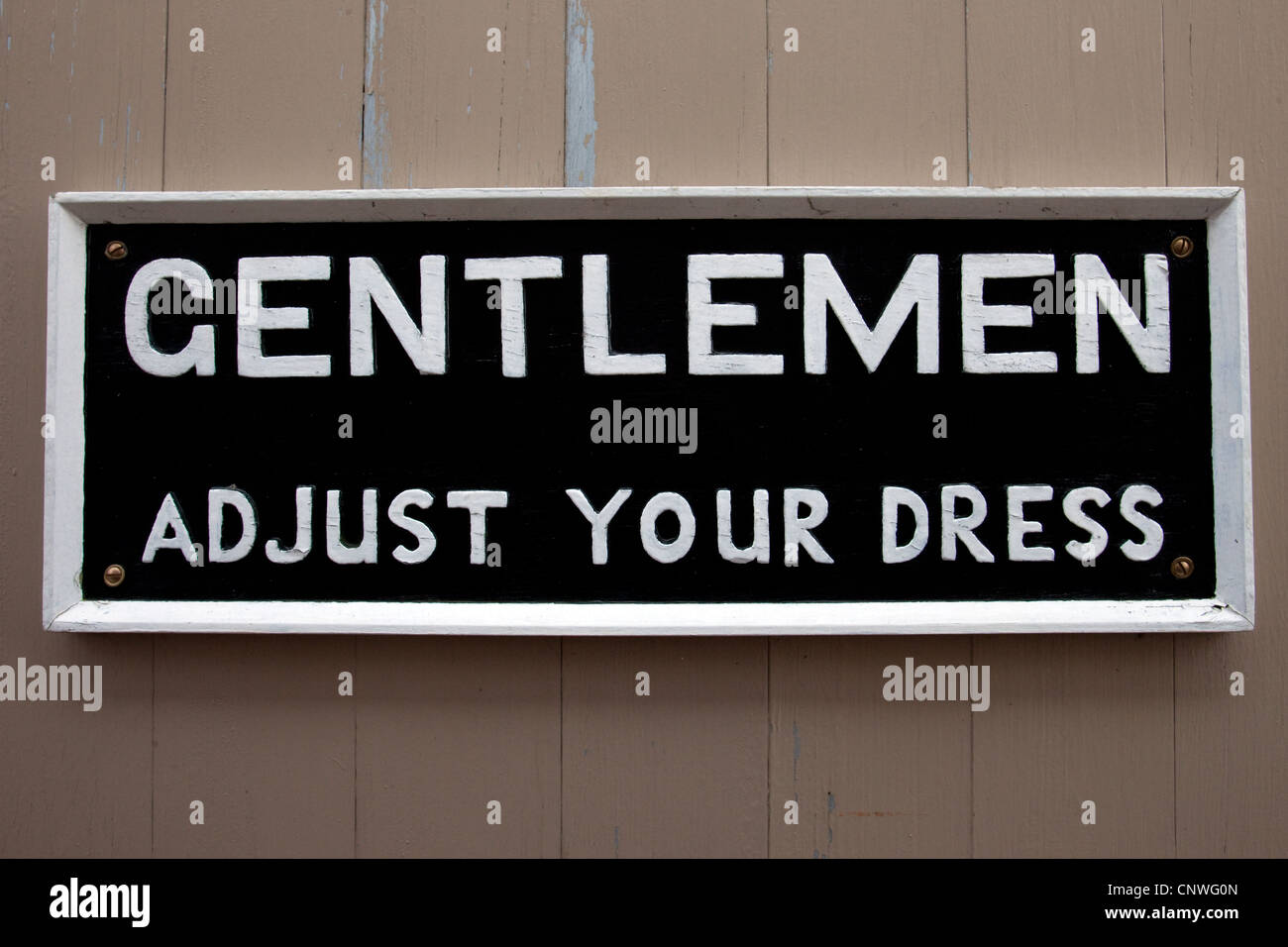 An old fashioned sign that was displayed on the exit wall of a gentleman's public lavatory in years gone by. Stock Photo