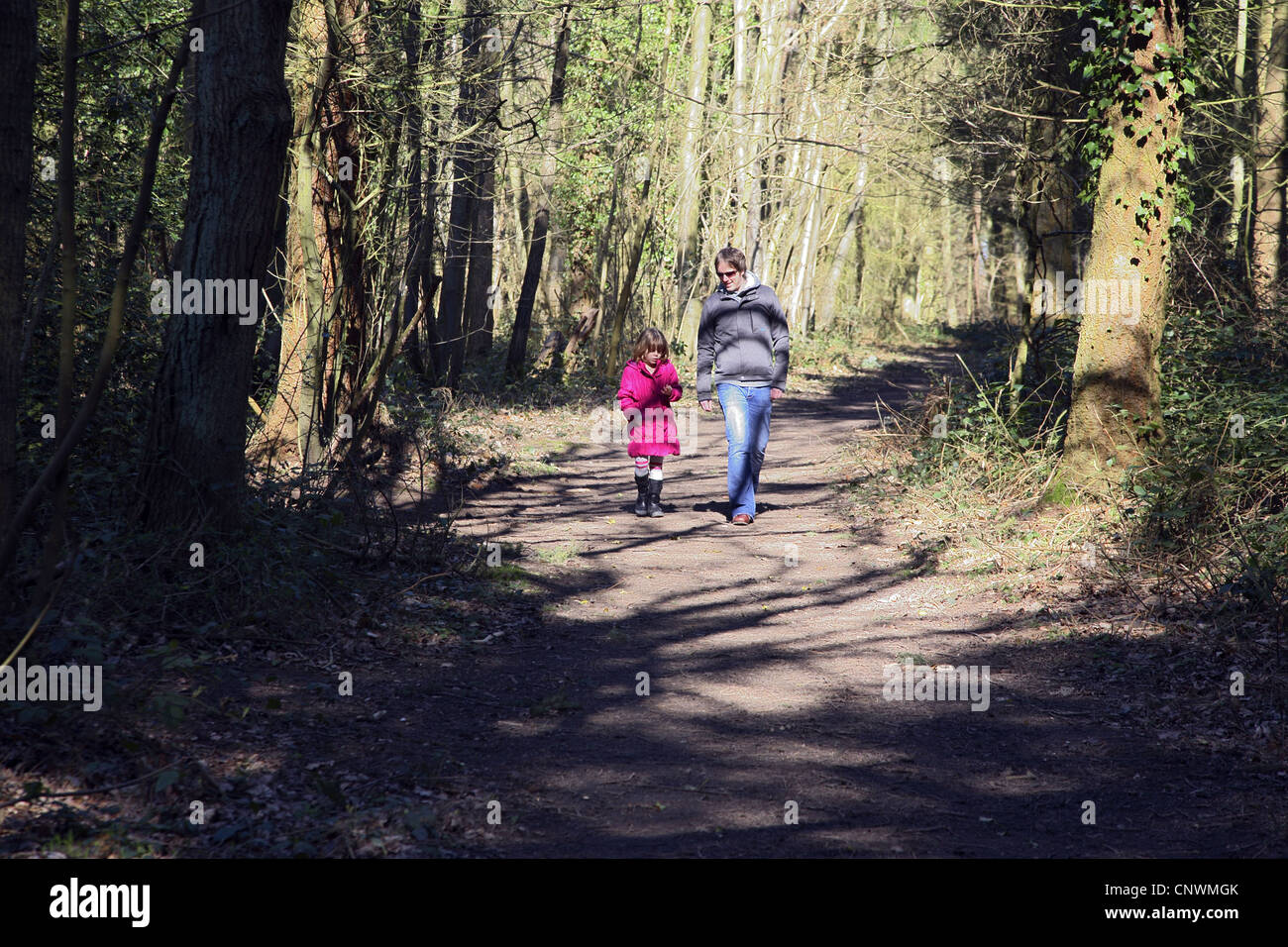 Father and daughter walking in the woods Stock Photo - Alamy