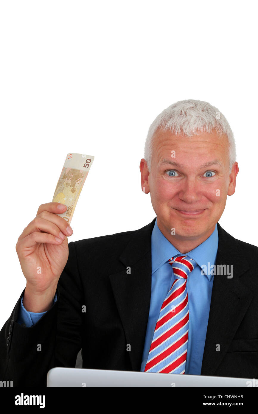 Senior Businessman with money and laptop laughing Stock Photo
