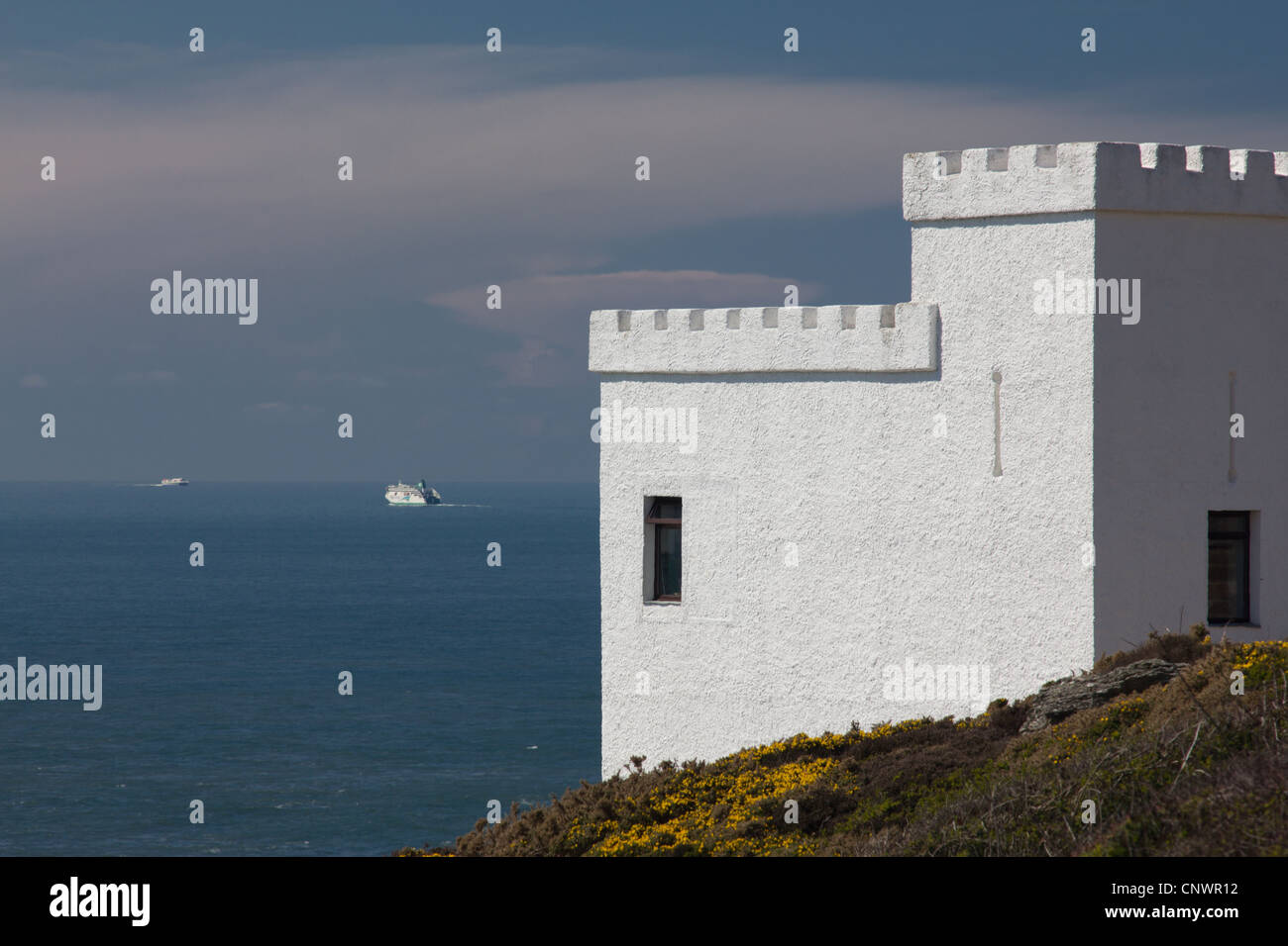 Tŵr Ellin, the Ellin Tower RSPB lookout near South Stack, Anglesey, with Irish and Stena Ferries on the horizon Stock Photo