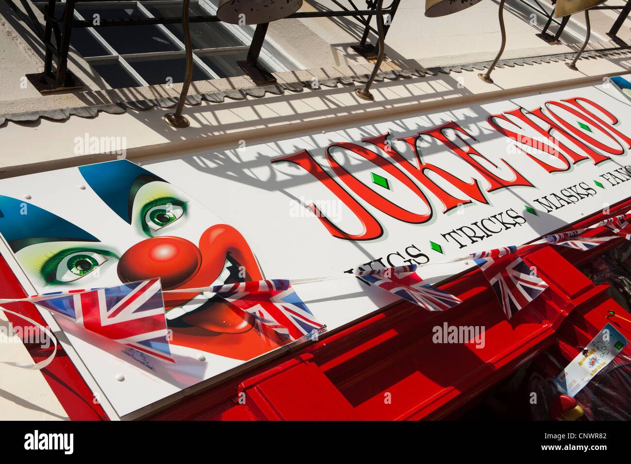 UK, England, Devon, Torquay, Vaughan Parade, Joke Shop sign with union jack flag bunting Stock