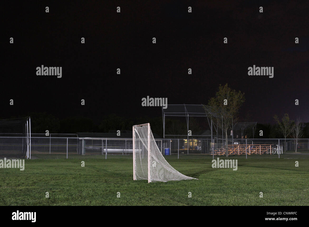 A soccer goal lit up in a dark, empty soccer field Stock Photo Alamy