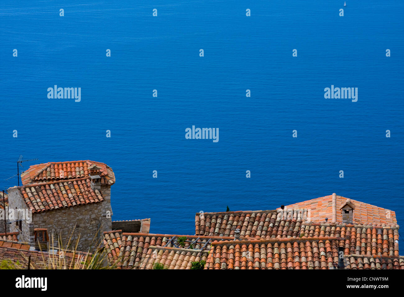 view down the roofs of the village down the steep coast at the open sea, France, �ze Stock Photo