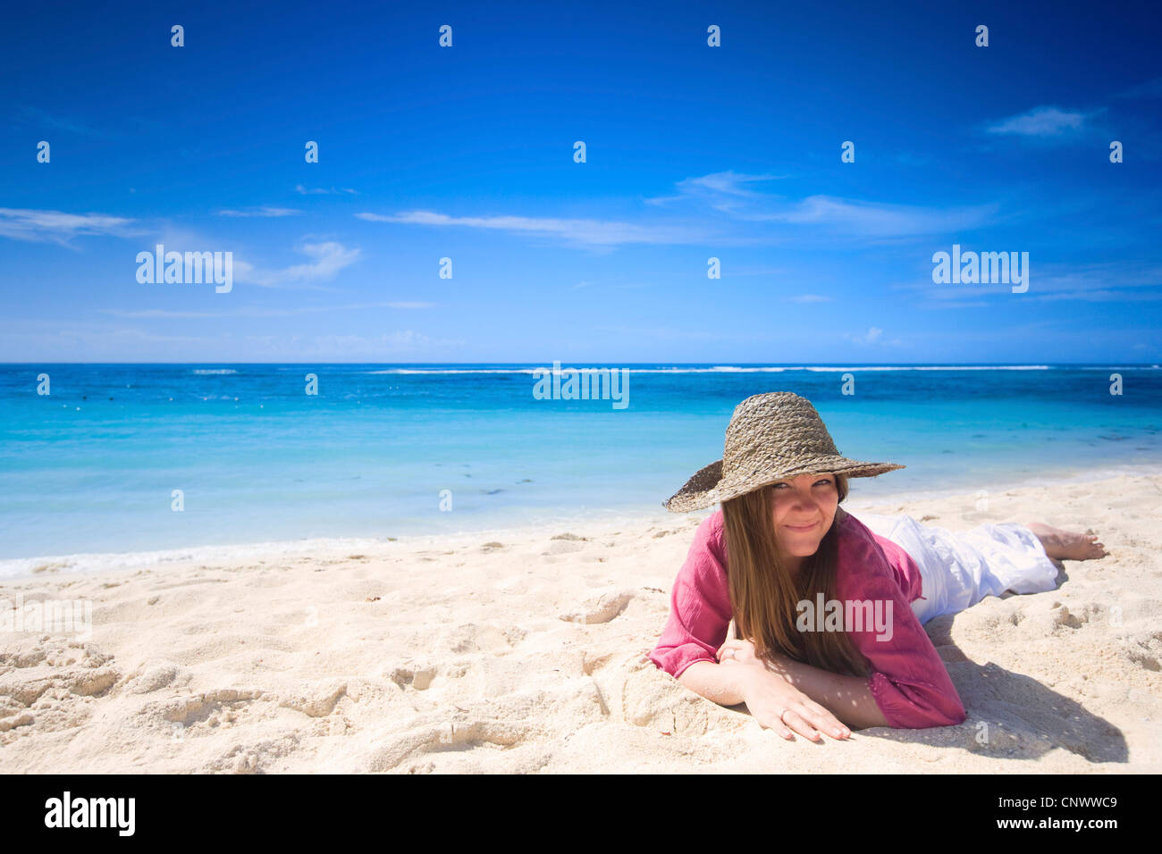 Happy young woman on white sand tropical beach, Maldives, Indian Ocean Stock Photo