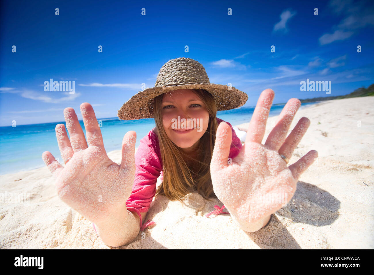 Happy young woman on white sand tropical beach, Maldives, Indian Ocean Stock Photo
