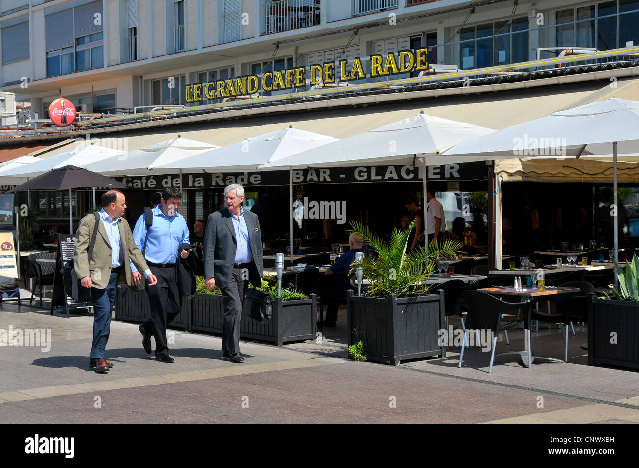 Business men walk past cafe Toulon France French Riviera Mediterranean