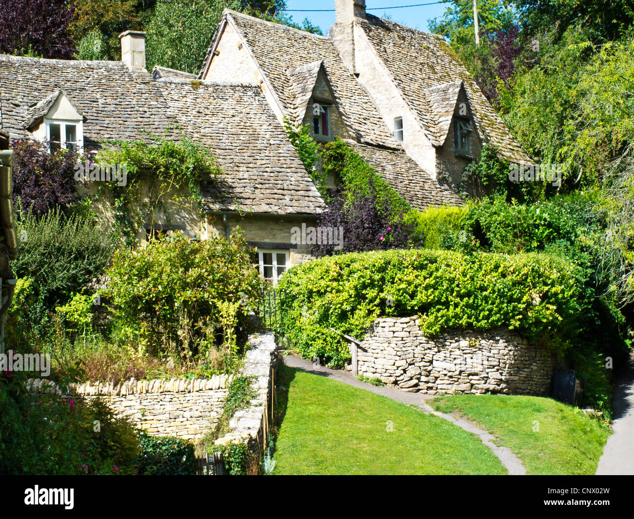 The picturesque cottages in Arlington Row in the pretty English Cotswold village of Bibury in Gloucestershire, England, UK. Stock Photo
