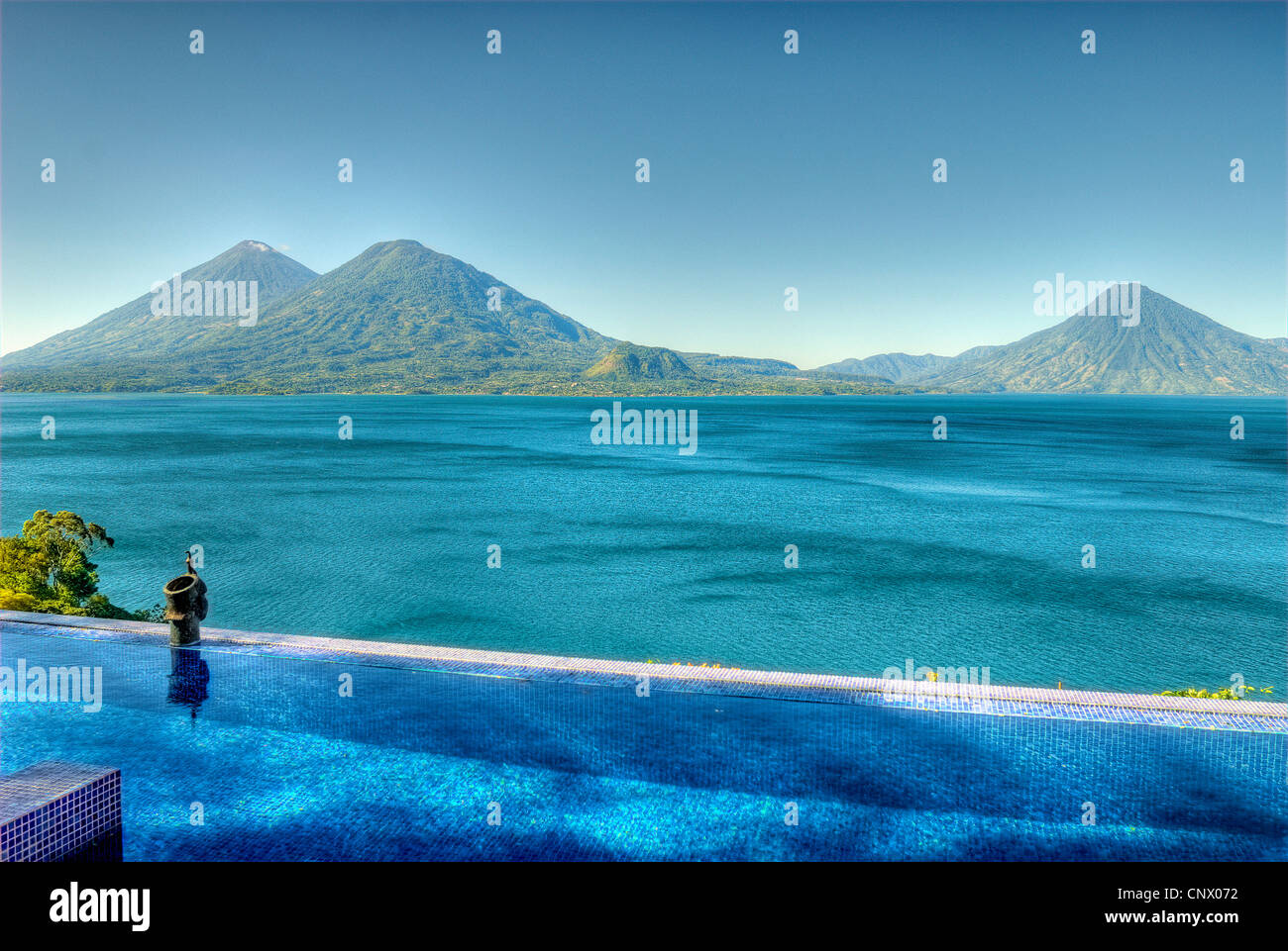 View of Lake Atitlan and Atitlan, Toliman and San Pedro volcanoes from the villa at Casa Palopo Hotel. Stock Photo