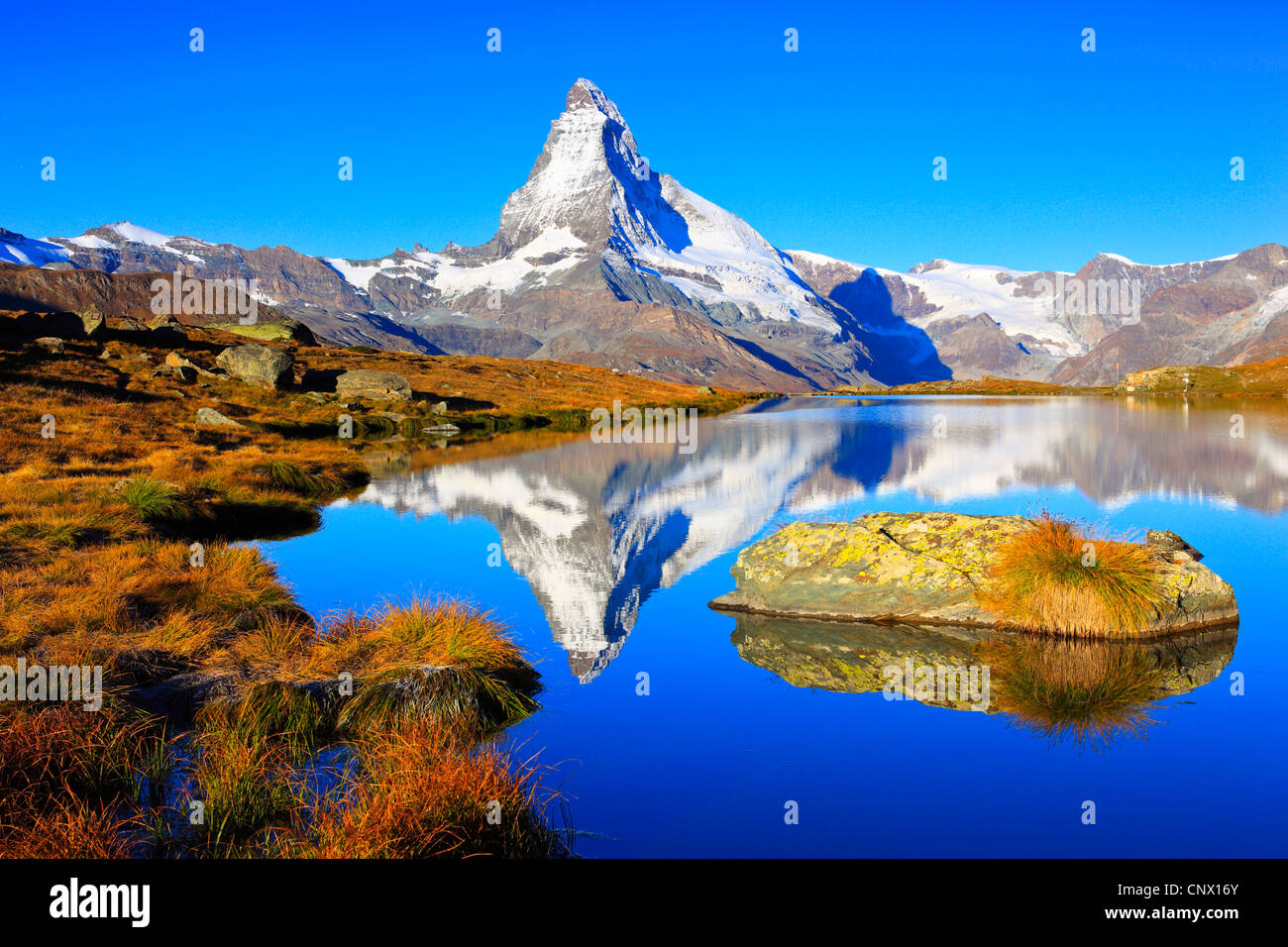 view from a mountain lake at the Matterhorn under clear blue sky, Switzerland, Valais Stock Photo