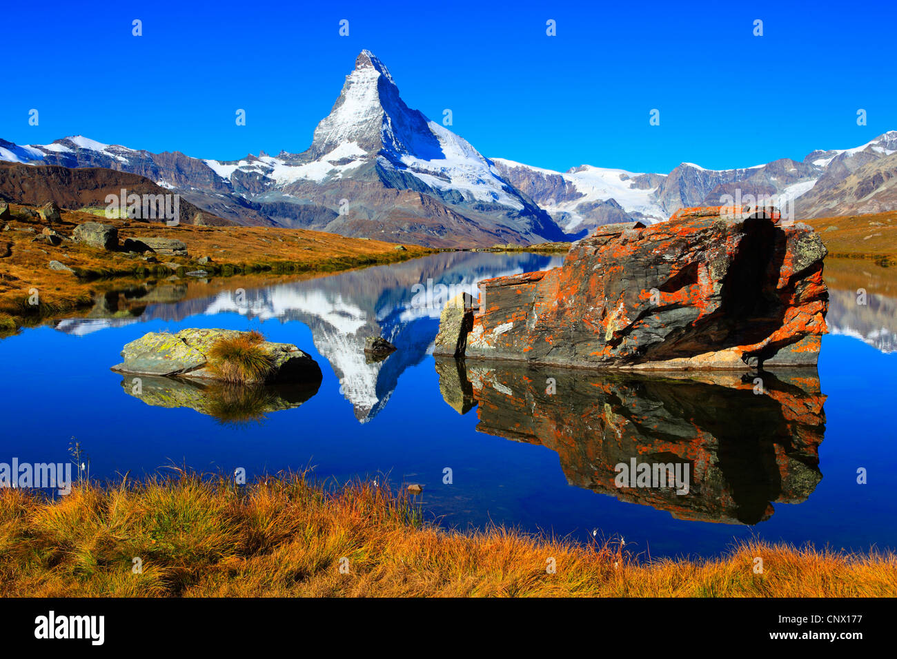 view from a mountain lake at the Matterhorn under clear blue sky, Switzerland, Valais Stock Photo